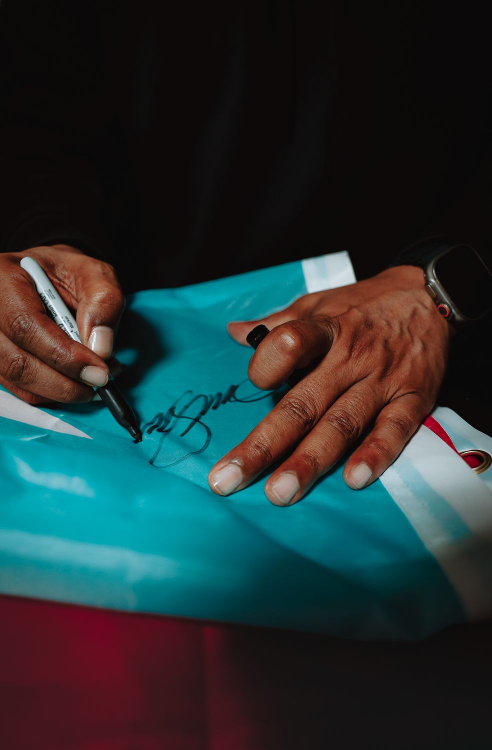Don Omar · signing a Puerto Rican flag